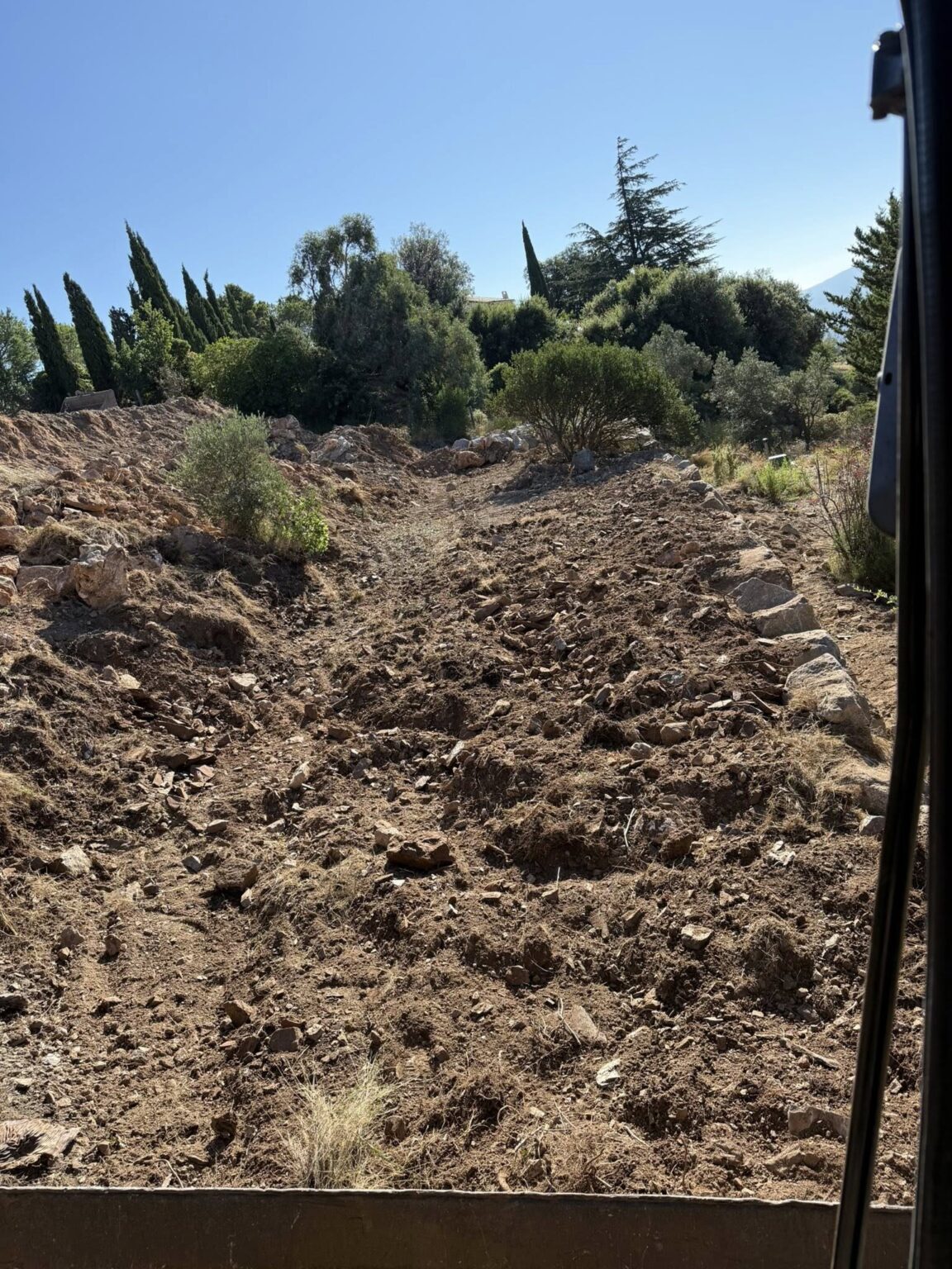 Création de paliers en enrochement pour structurer le terrain et lui donner du relief - Apport de terre végétale sur l’ensemble du jardin, prêt à être végétalisé.